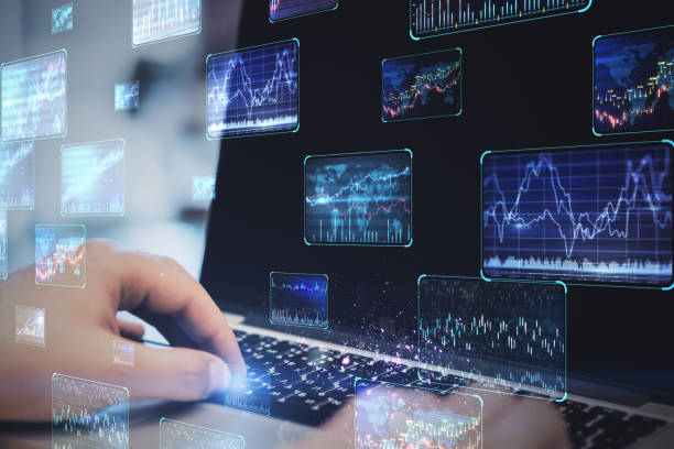 istock Close up of hands using notebook with various forex screens on blurry background. Cryptocurrency, bticoin trading and finance concept. Double exposure. 1369348286