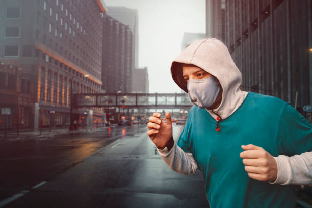 istock Man Running in polluted city 1369348959