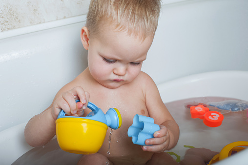 Toddler boy bathes in bathroom close-up.