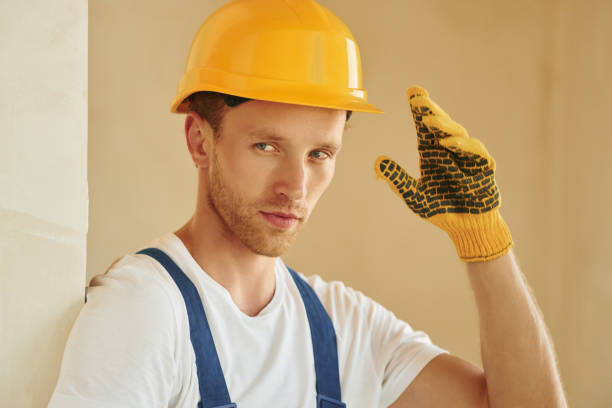 istock Portrait of young man working in uniform at construction at daytime 1369350100