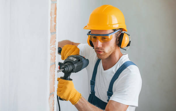 istock Portrait of young man working in uniform at construction at daytime 1369350125