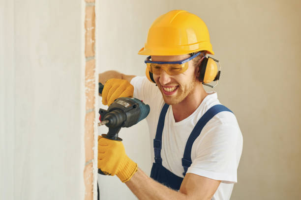istock Portrait of young man working in uniform at construction at daytime 1369350128