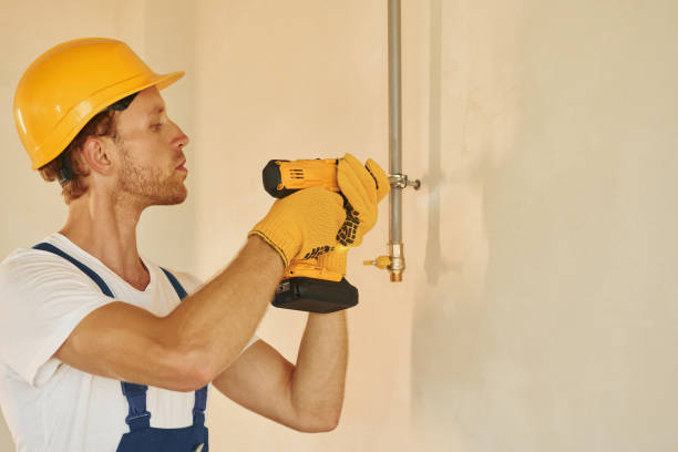istock With equipment. Young man working in uniform at construction at daytime 1369350205