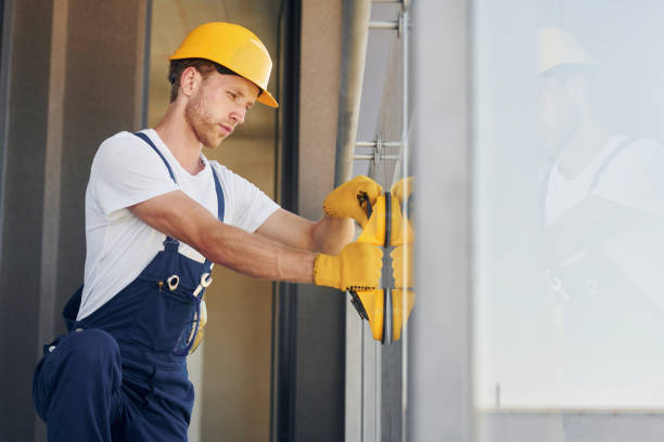 istock Side view. Young man working in uniform at construction at daytime 1369350374