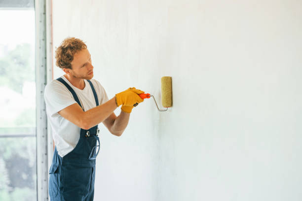 istock Builder at his job. Young man working in uniform at construction at daytime 1369350835
