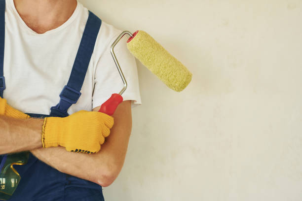 istock Builder at his job. Young man working in uniform at construction at daytime 1369351049