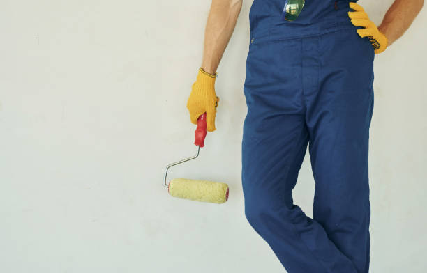 istock Builder at his job. Young man working in uniform at construction at daytime 1369351050
