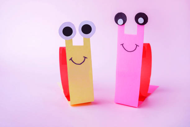 istock Valentines day craft, greeting card. DIY and kid's creativity. Step by step instruction: how to make snail with heart. Step7 finished work: paper snails with hearts on back.. 1369352384