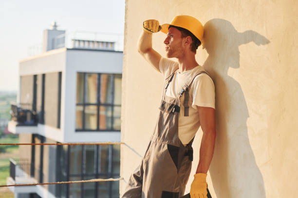 istock Project manager. Young man working in uniform at construction at daytime 1369352395