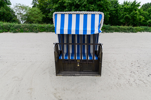 Closed beach chair as a symbol for tourism in the pandemic, end of vacation.