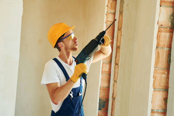 istock In hard hat. Young man working in uniform at construction at daytime 1369353230