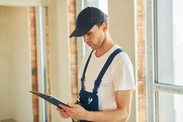 istock In hard hat. Young man working in uniform at construction at daytime 1369353242