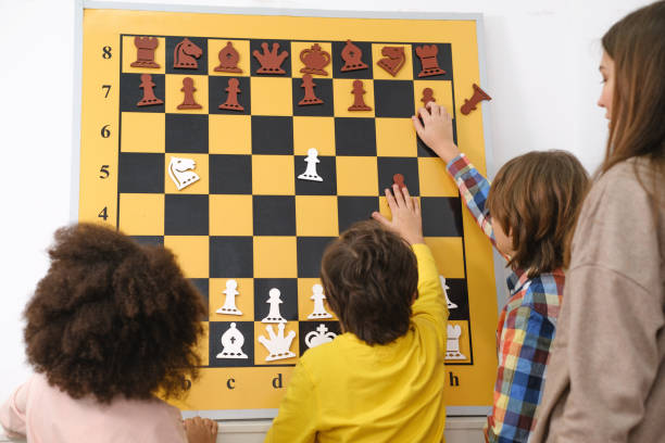 istock multiethnic kids playing chess board game at school 1369353566