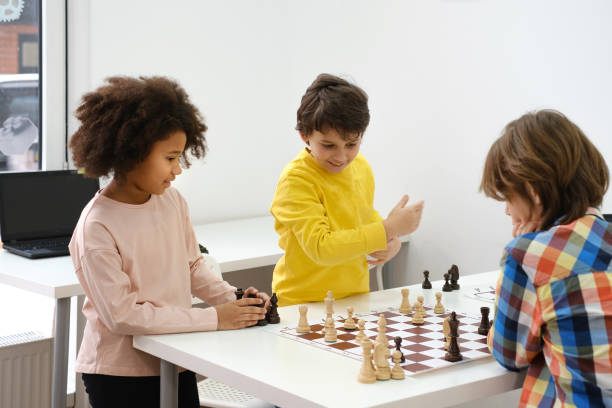 istock multiethnic kids playing chess board game at school 1369353645