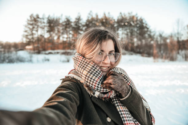 istock Young woman taking selfie outdoors in winter 1369353714