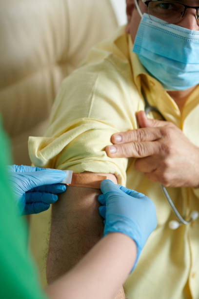 istock Nurse Sticking Bandage on Injection Site 1369353820