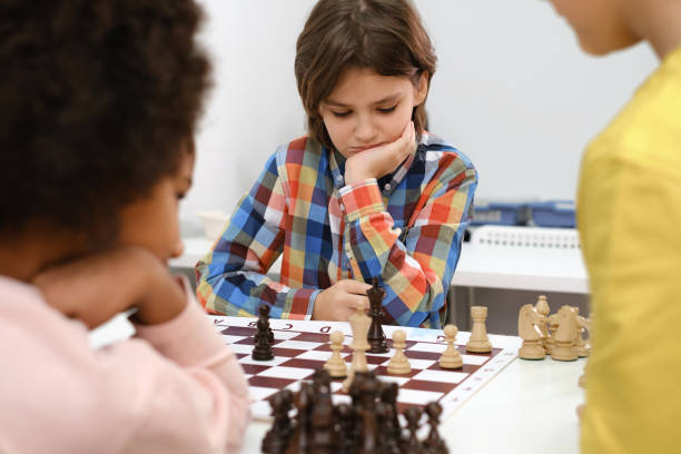 istock multiethnic kids playing chess board game at school 1369354949