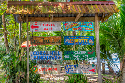 Cahuita, Costa Rica- January 26, 2020 :  \n\nAt the edge of cahuita beach, these colored panels indicate accommodations or nearby activities. Tourists appreciate being able to find the sites easily with to these indications