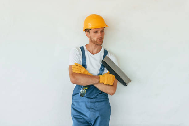 istock Posing for the camera. Young man working in uniform at construction at daytime 1369355511