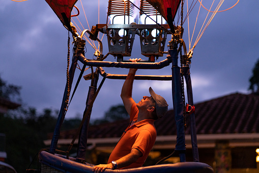 large hot air balloon is in the farm of santa fe de antioquia. it is inflated with fire to achieve its elevation and have family fun