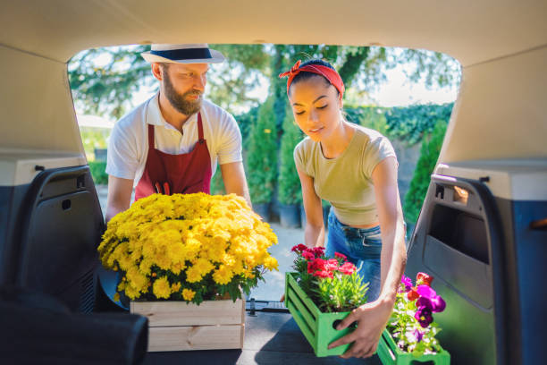 istock Florist placing flowers in client's car 1369356896