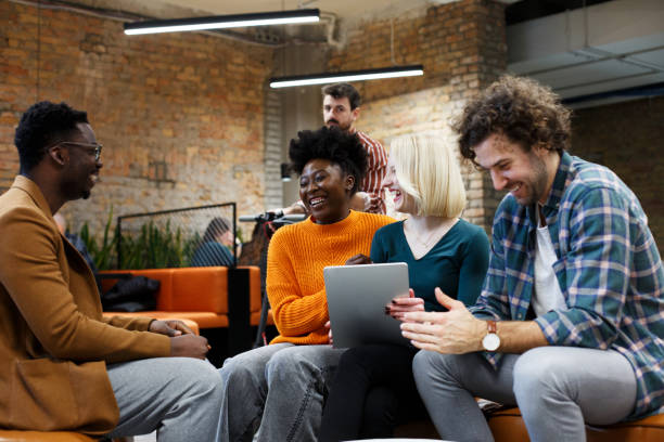 istock Three young experts are sitting and talking, t in a start-up company. 1369357272