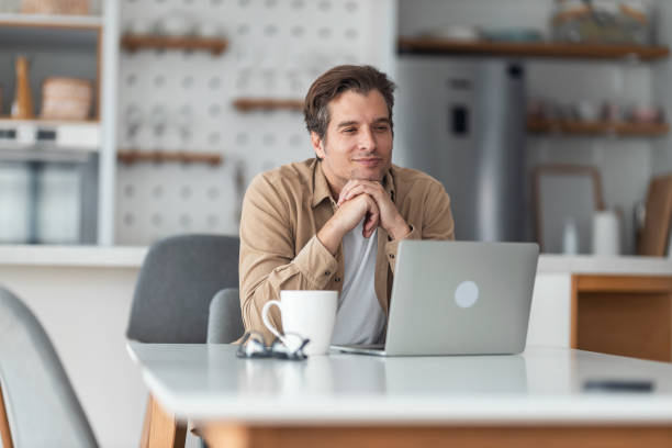 istock Freelancer fantasizes about vacation while working remotely from home. 1369357336