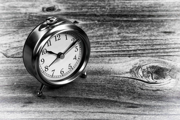 istock Rustic wooden desktop table with antique retro clock 1369357491