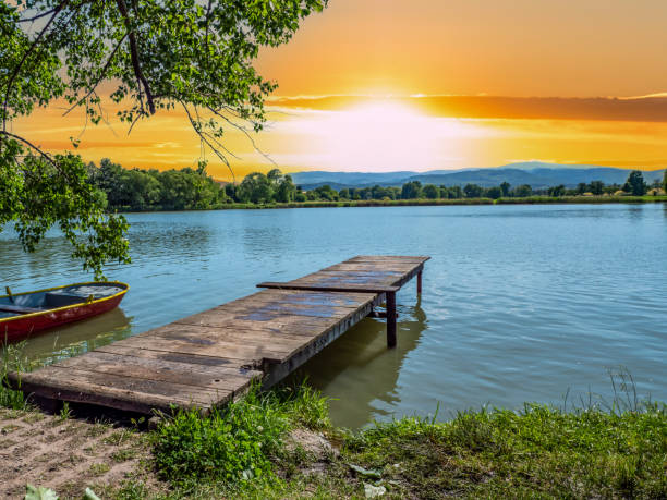 Jetty with a lake in the sunset Jetty with a lake in the sunset mecklenburg lake district photos stock pictures, royalty-free photos & images