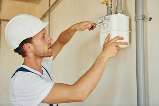istock Repaiting the pipes. Young man working in uniform at construction at daytime 1369358731