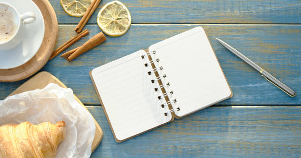 istock composition with a cup of coffee and a croissant on the table on the Place 1369358802