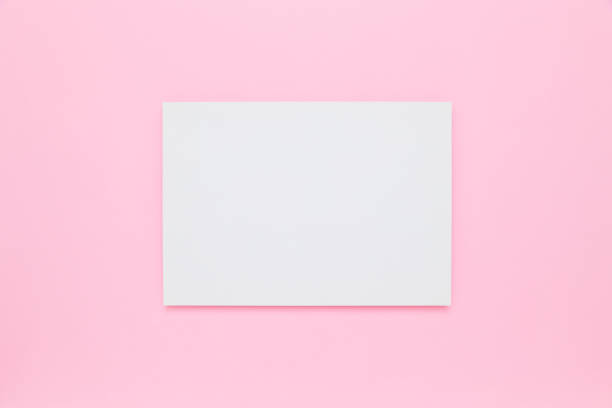 istock Blank white paper on pastel pink flat lay background. Minimalism. Copy space for text 1369358832