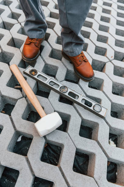 istock Making of floor. Young man working in uniform at construction at daytime 1369358887