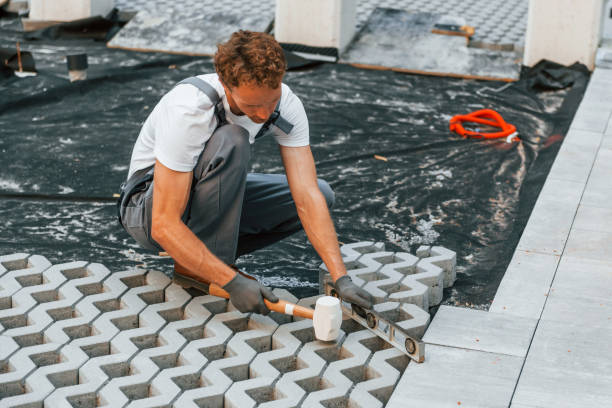 istock Grey colored clothes. Young man working in uniform at construction at daytime 1369358944