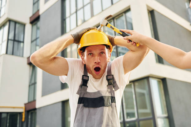 istock Standing near modern buildings. Young man working in uniform at construction at daytime 1369360441
