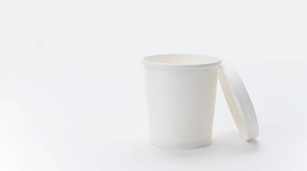istock White paper cup with a lid on a light background. copyspace. 1369360572