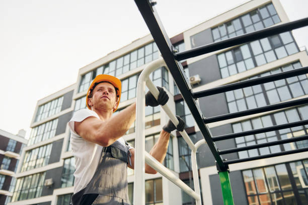 istock Looking far away. Young man working in uniform at construction at daytime 1369360583