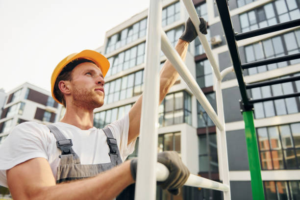 istock Looking far away. Young man working in uniform at construction at daytime 1369360589