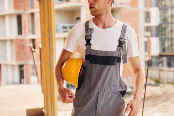 istock Big project. Young man working in uniform at construction at daytime 1369361329
