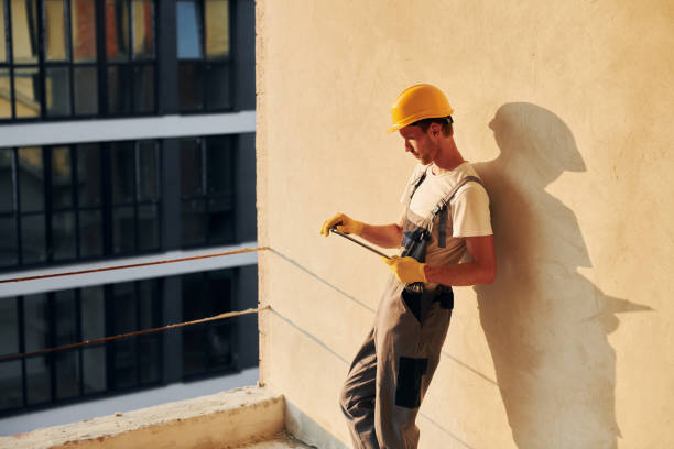 istock Illuminated by sunlight. Young man working in uniform at construction at daytime 1369361606
