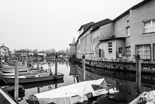 Monochrome shot of some small fishing boats in an old fishing port.
