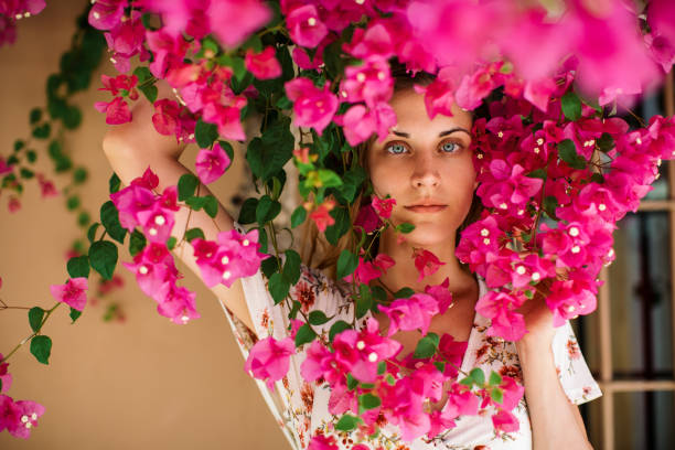 istock Beautiful woman among blossom tree 1369365423
