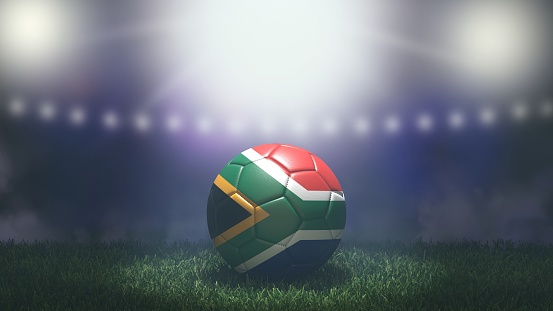 Soccer ball in flag colors on a bright blurred stadium background. South Africa. 3D image