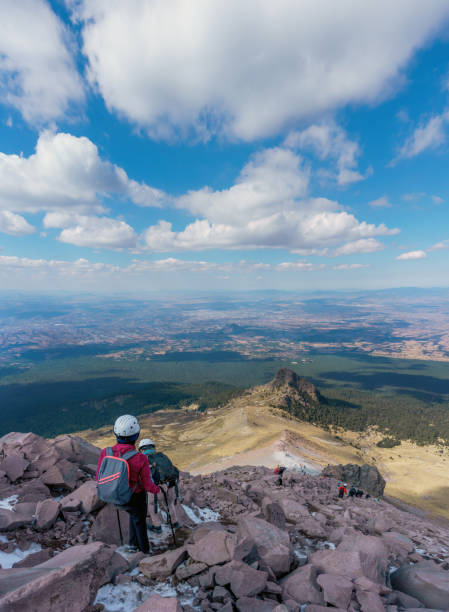 istock Young woman with backpack in malinche volcano 1369366935