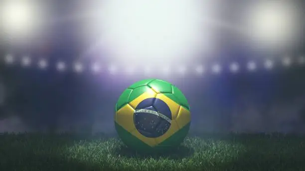 Photo of Soccer ball in flag colors on a bright blurred stadium background. Brazil.