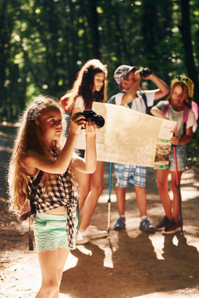 istock With touristic equipment. Kids strolling in the forest 1369367841