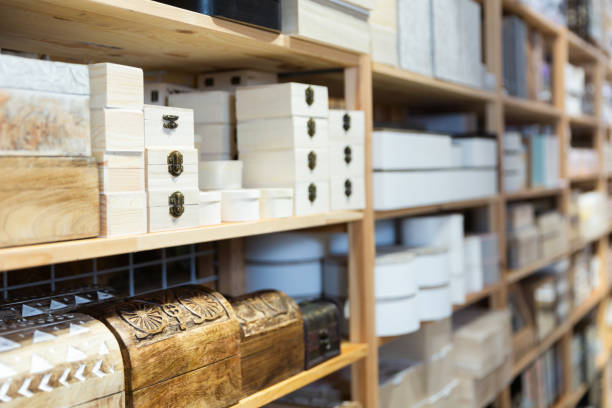 istock Wooden caskets on shelve in store 1369367854