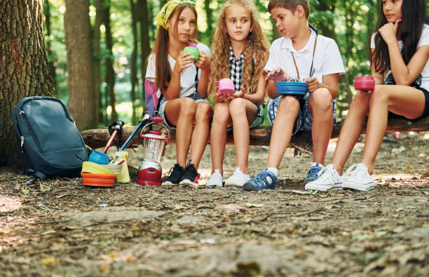 istock Taking a break. Kids strolling in the forest with travel equipment 1369368714