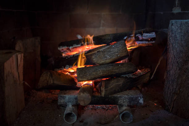 istock Traditional stone-made fireplace with burning wood. 1369373813