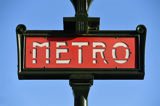 Paris, France-02 07 2022:An old red Paris metro sign at the entrance of a subway station in Paris, France.